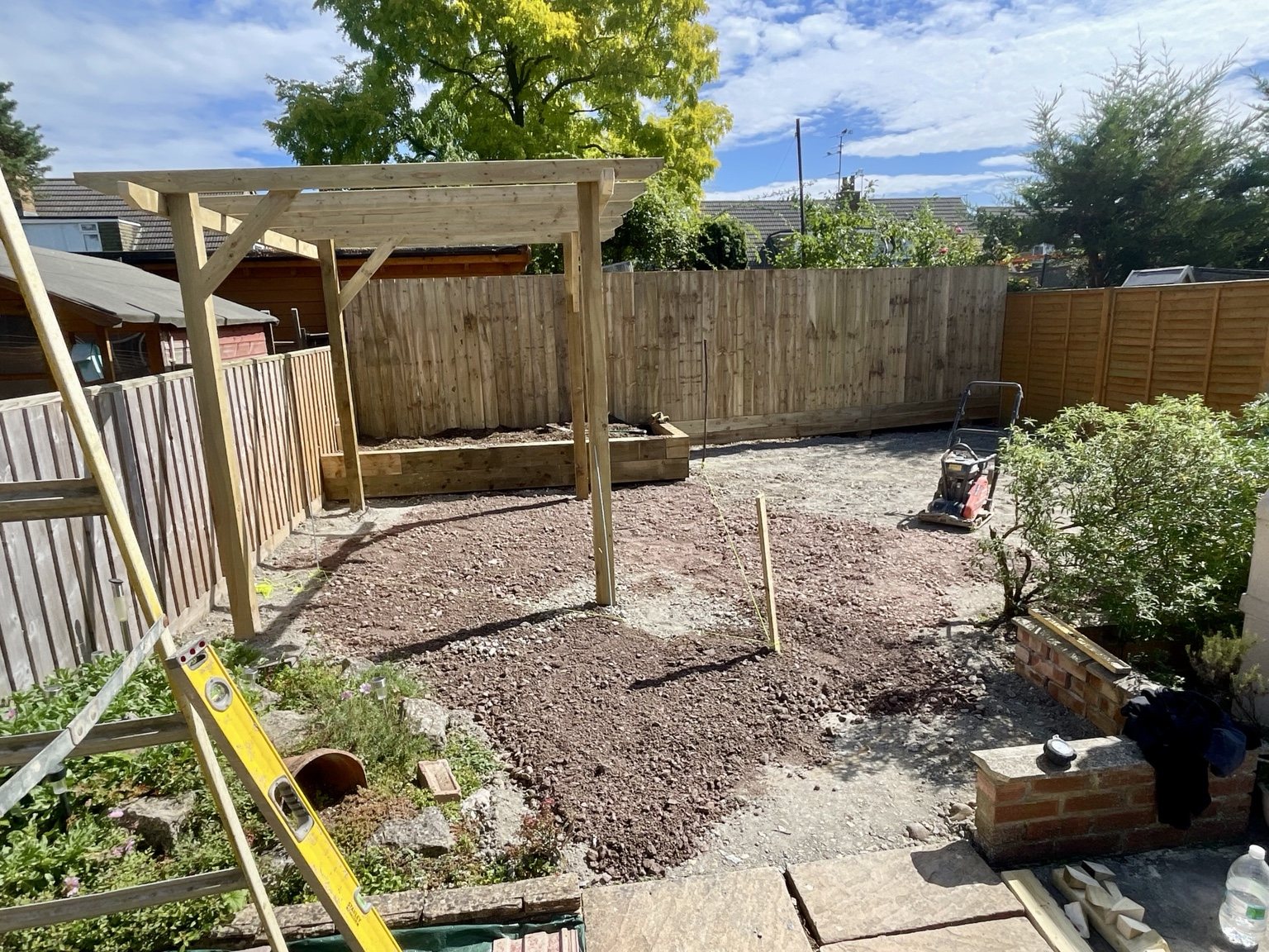 Early stages of a sandstone patio and garden transformation in Gloucestershire